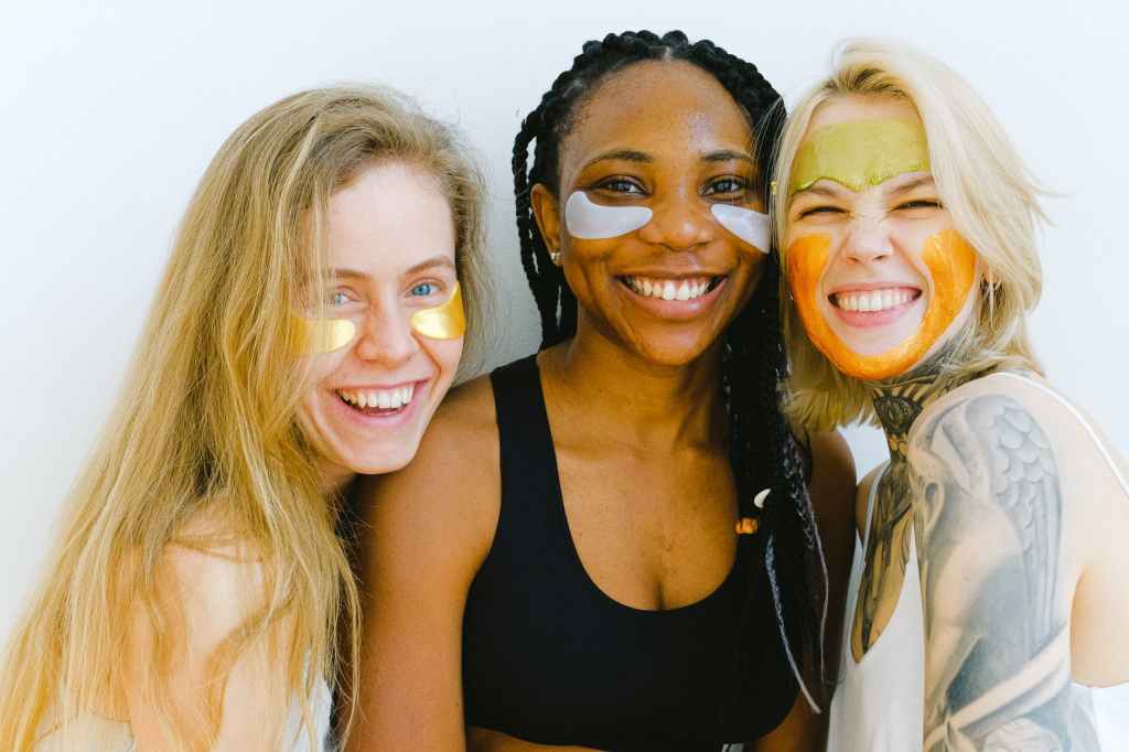 Female friends celebrate Galentine's Day wearing face masks. 